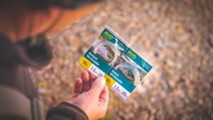 Francis fly held in anglers hand